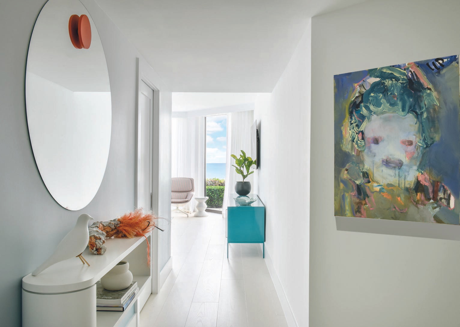 A mirror from Collector signals the primary bedroom along with art by Menghan Qi from SCAD Art Sales. PHOTOGRAPHED BY KEN HAYDEN