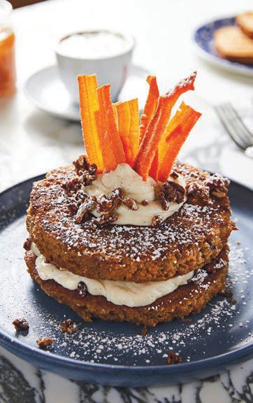 Café Americano’s carrot cake French toast features three slices of thick-cut brioche, grilled in spiced batter, filled with carrot, raisin and pecan cream cheese and topped with candied carrots. PHOTO: COURTESY OF CAFE AMERICANO