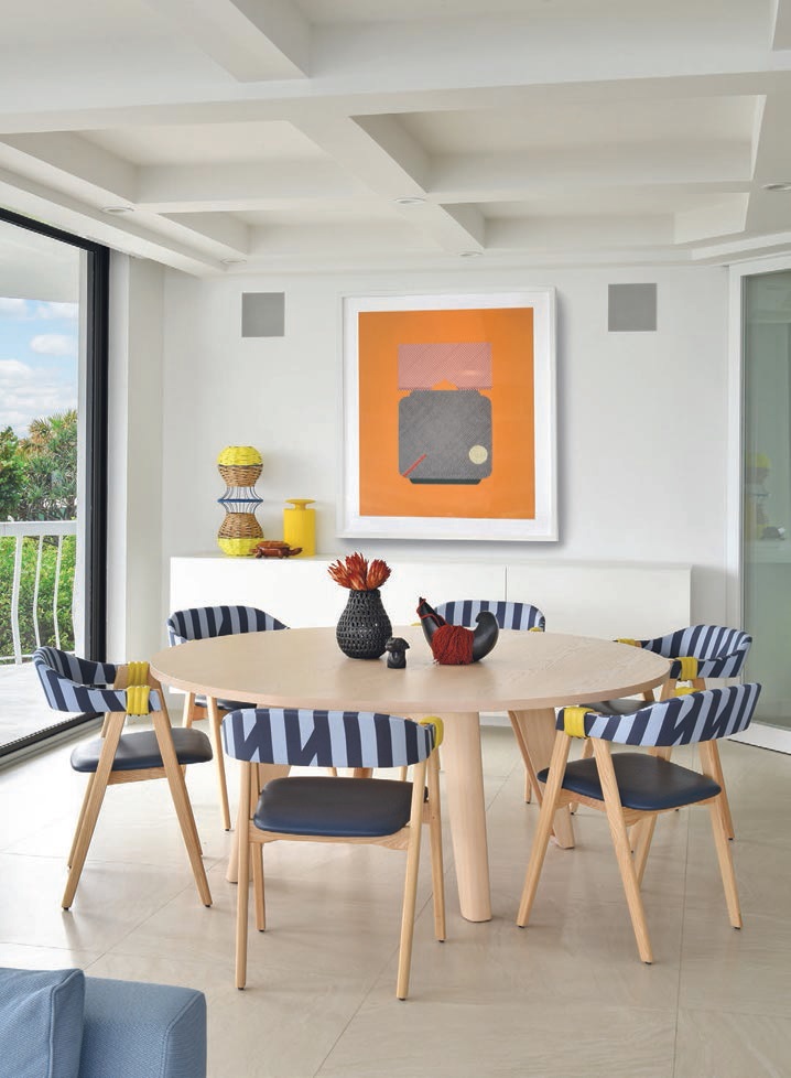 Moroso chairs with Sir Stripe-a-lot fabric by Ghislaine Viñas for HBF Textiles circle a dining table from Scandinavian Spaces beneath art by Alyson Fox from ArtStar PHOTOGRAPHED BY KEN HAYDEN