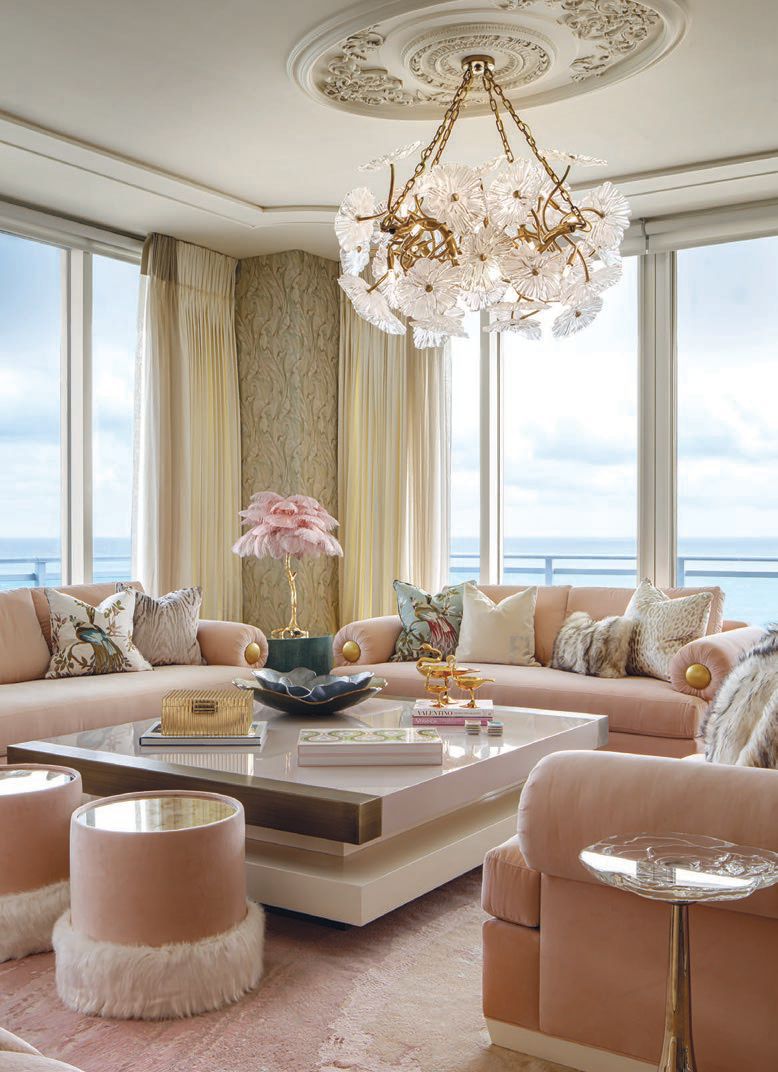 The living room features velvet upholstery on the sofas and ottomans, as well as floral motifs, most noticeably in the crystal chandelier PHOTOGRAPHED BY BRANDON BARRÉ