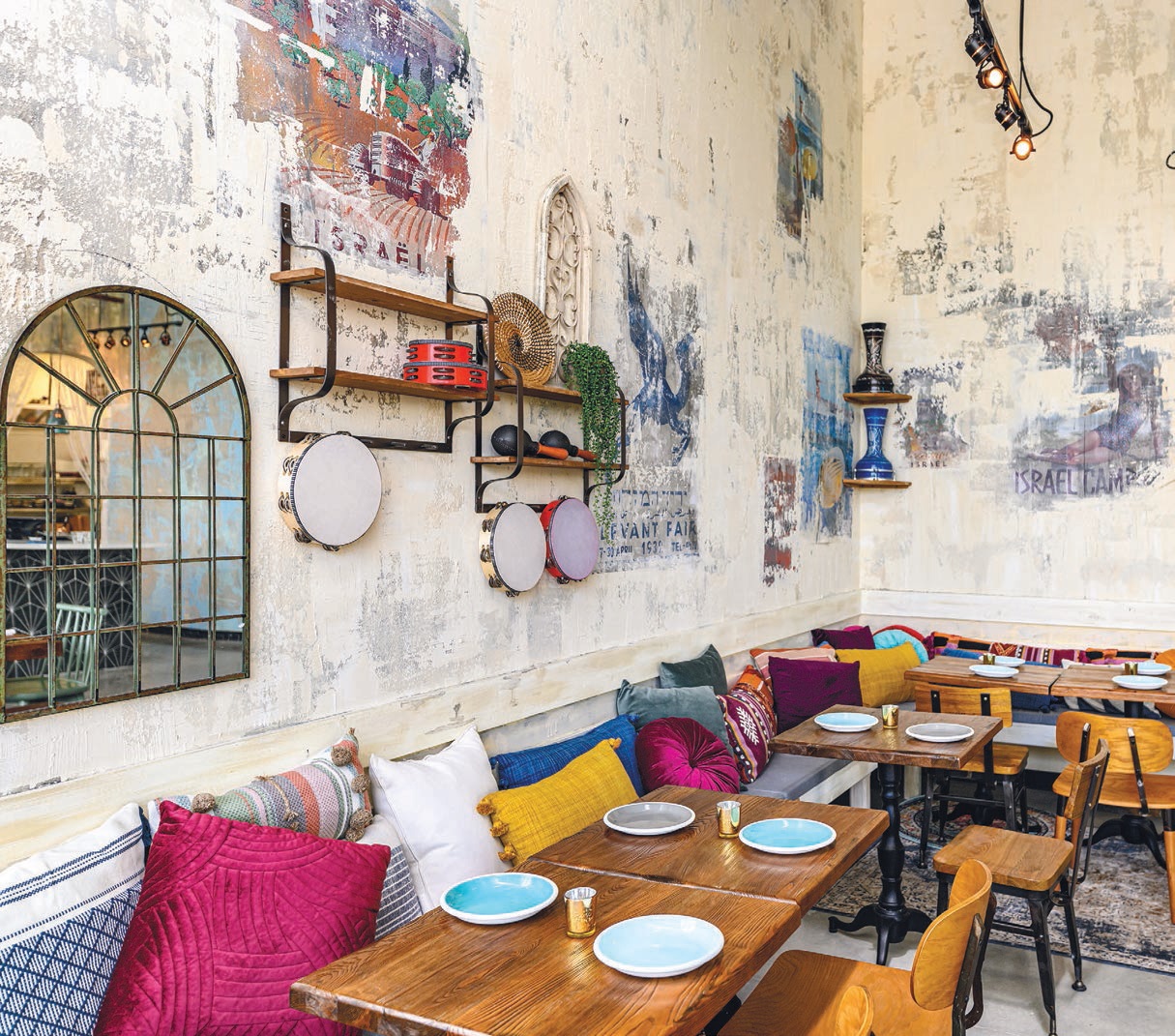 Jaffa’s gorgeous interior design pays homage to its Israeli roots, boasting colorful accent pillows, posters and props PHOTO BY SALAR ABUAZIZ
