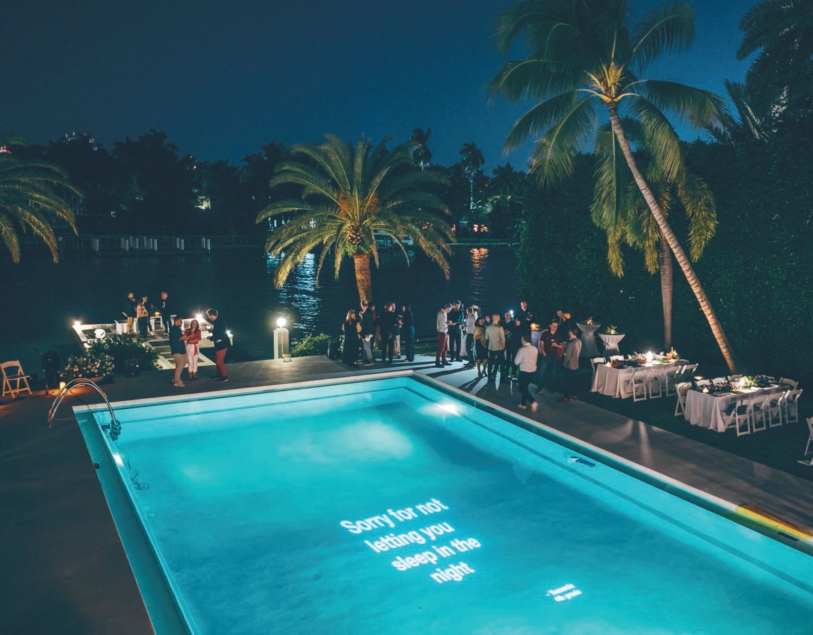 Kids’ poetry projected in a pool during O, Miami PHOTO BY: JAVIER SANCHEZ